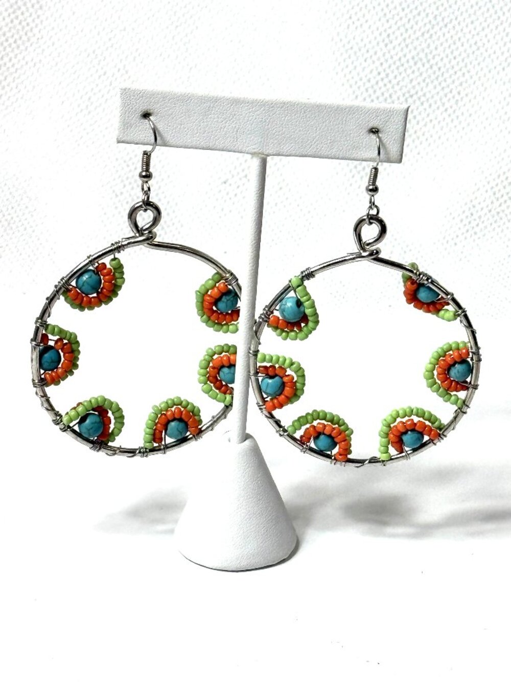 Large beaded hoop pierced earrings.